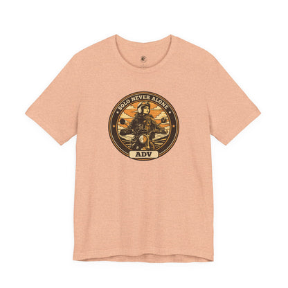 Pink t-shirt with a graphic design featuring a person on a motorcycle and text on a white background