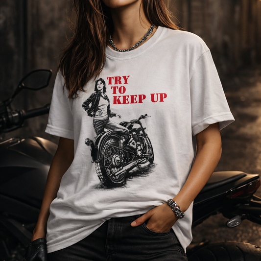 Person wearing a white t-shirt with a graphic design and text, standing next to a motorcycle.